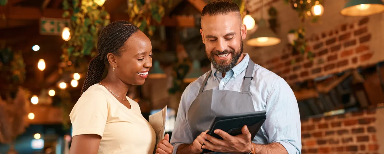 Two people looking at a tablet